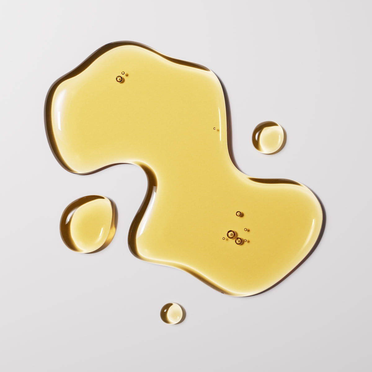 Gold liquid droplets on a light gray background