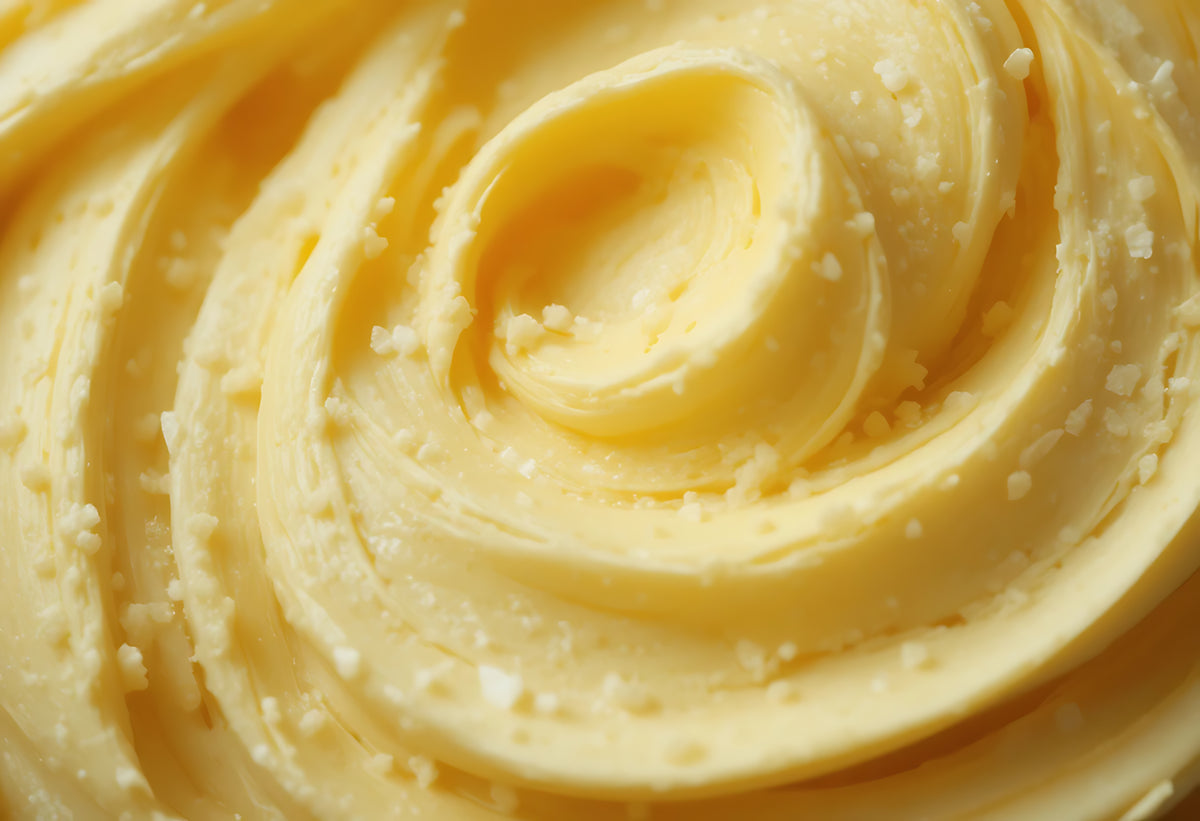 Close-up of a swirl of mango butter cream with a textured surface