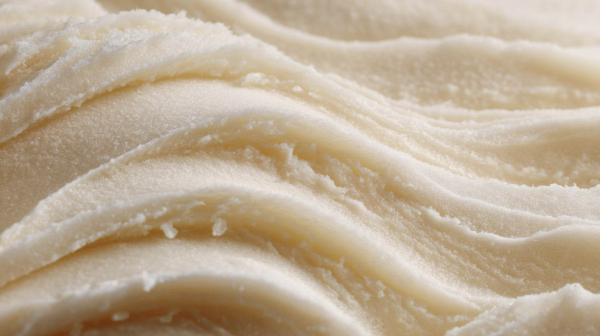 Close-up of smooth, beige-colored shea butter